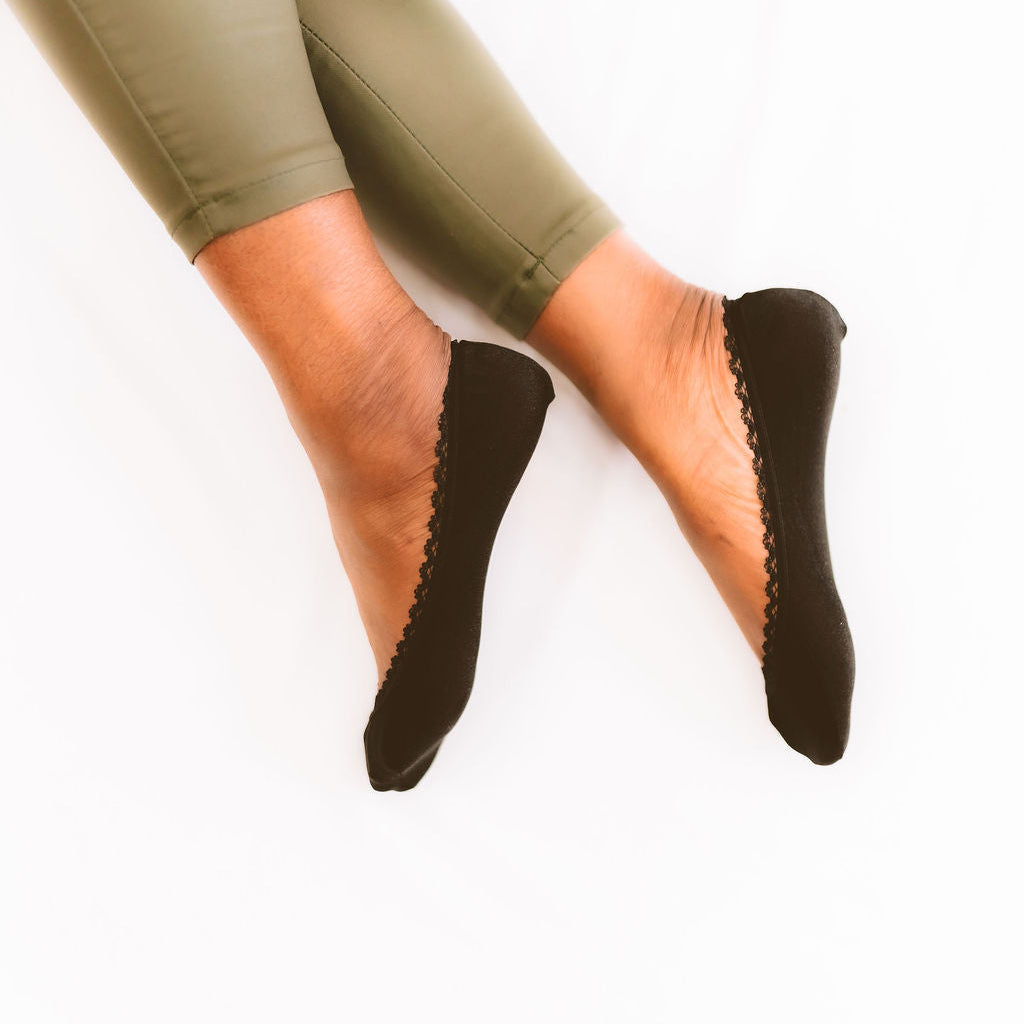 Black no-show footies on women's feet - Arbella Style invisible socks worn with shoes