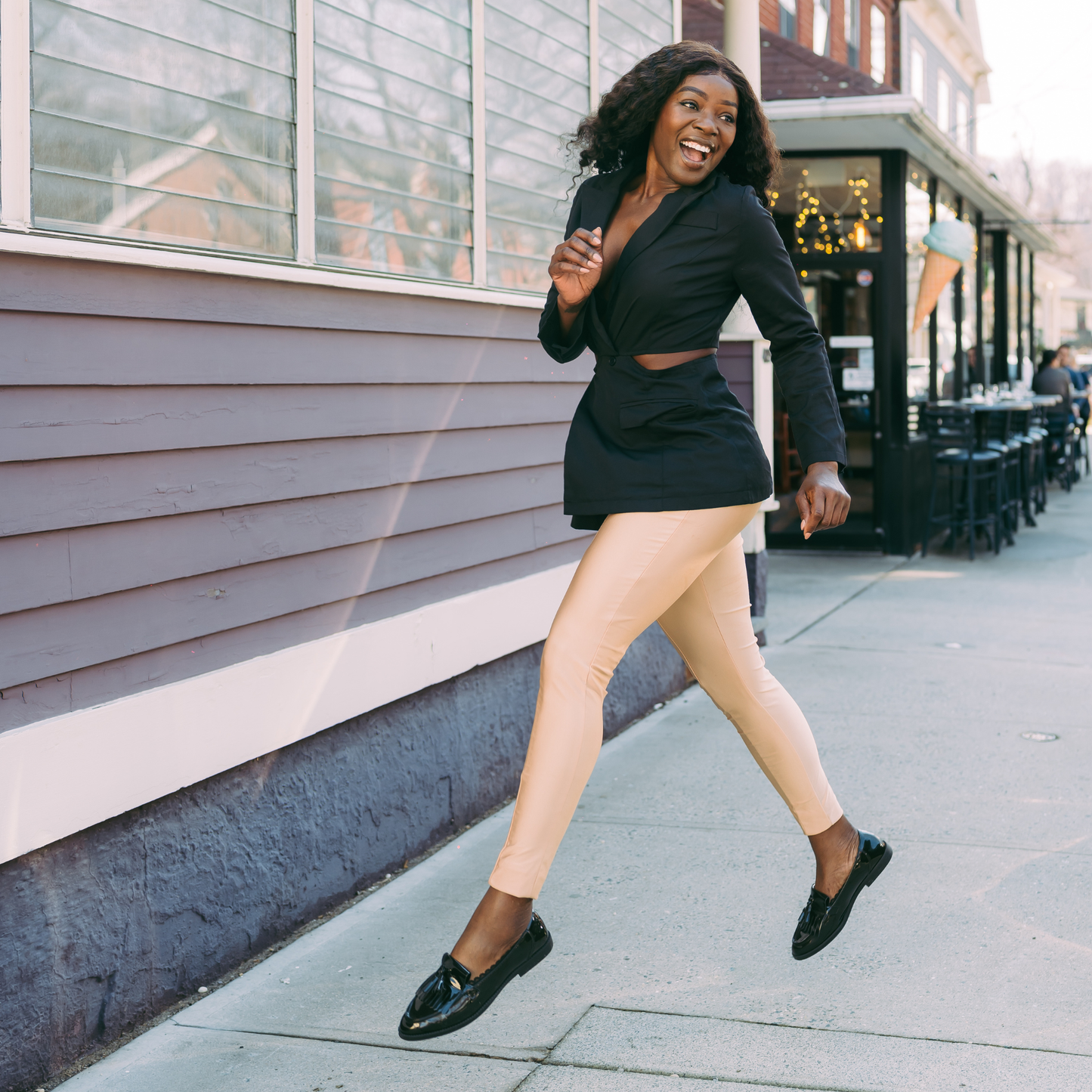 Black woman jumping showing Arbella Style stay-put footies - no-slip socks that stay on during movement