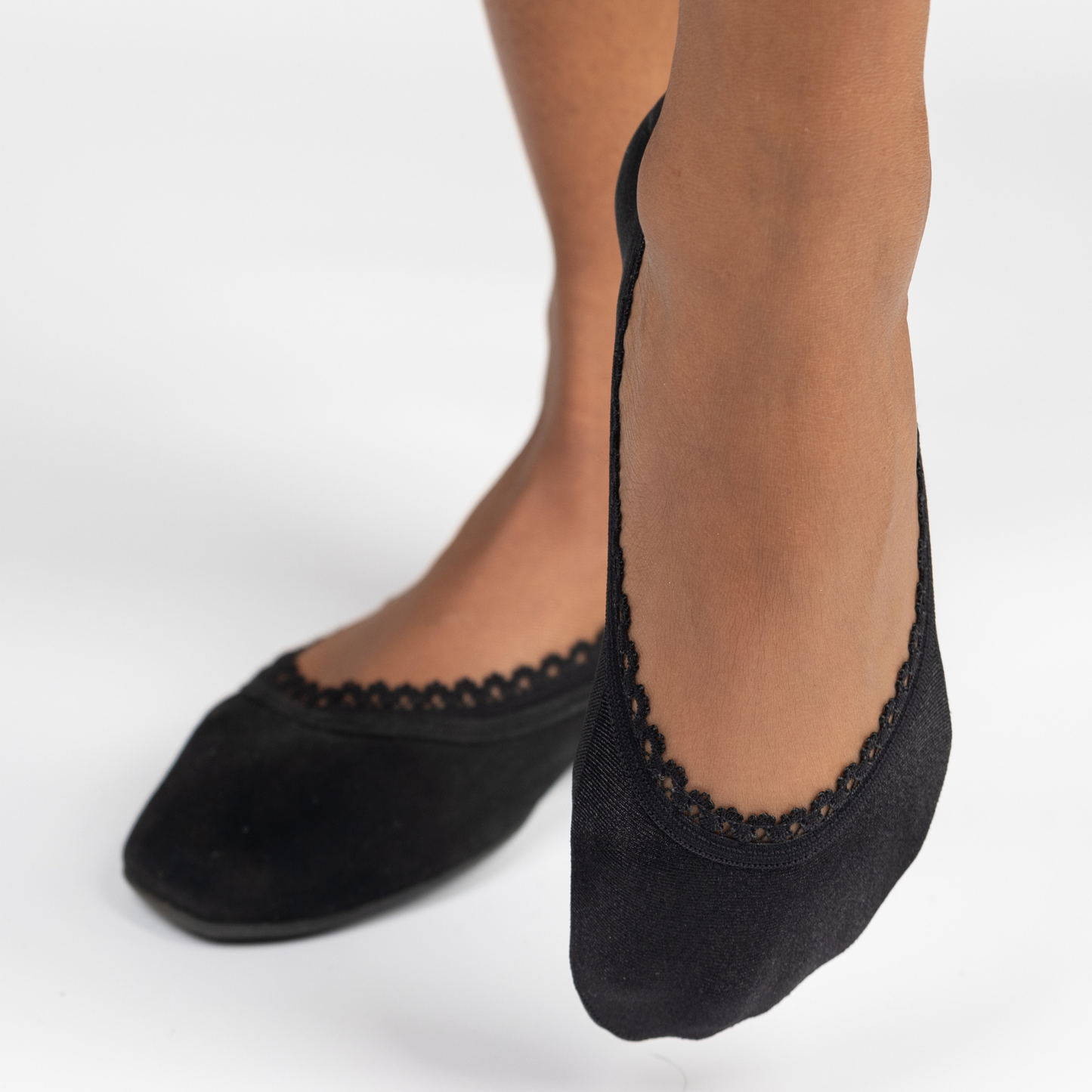 Black woman close-up modeling Arbella Style black footies - premium no-show socks