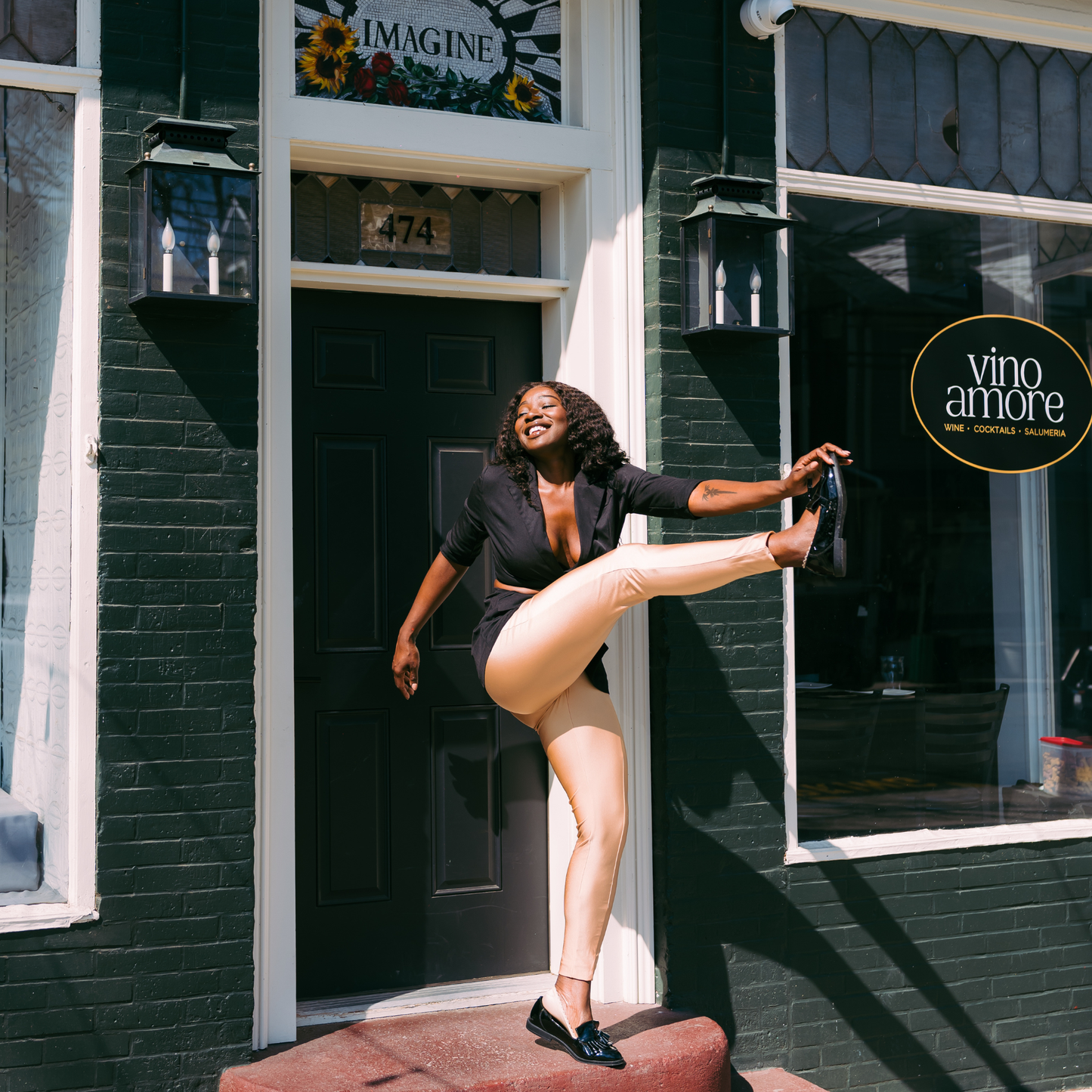 Woman kicking leg up showing Arbella Style stay-put footies - no-show socks that stay in place during movement